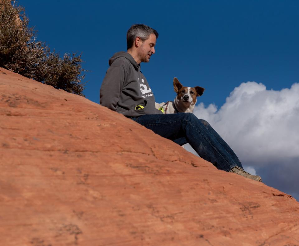 Person hiking with dog in Utah desert