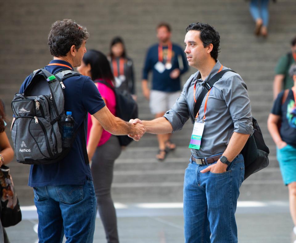 Two people shaking hands at a conference